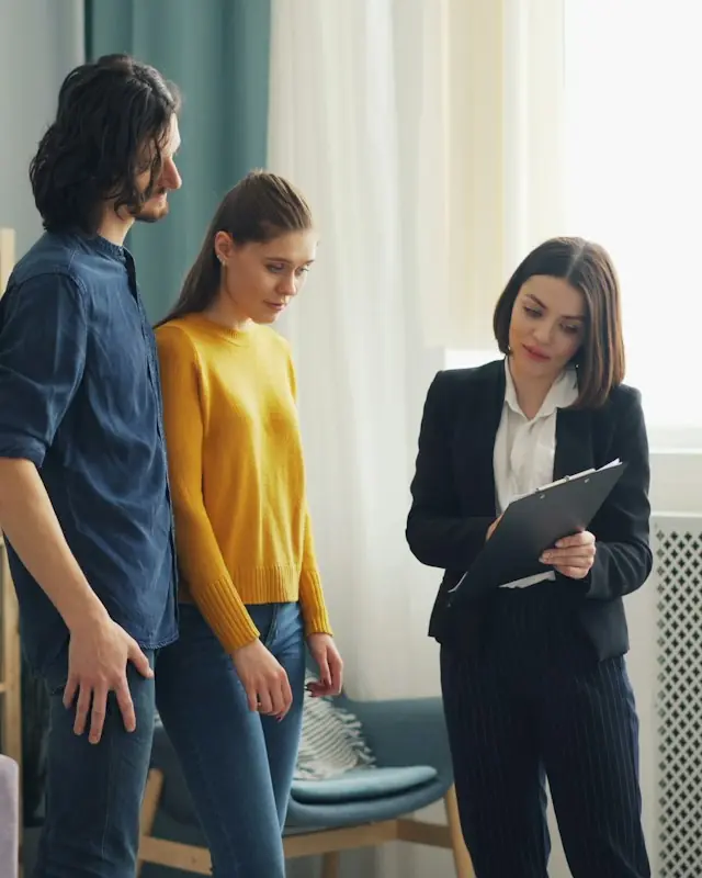 A letting agent showing a couple around a home